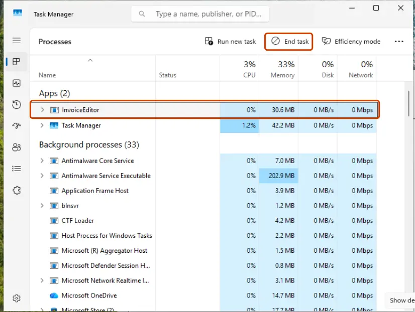 The frozen app selected in Task Manager and the End task button